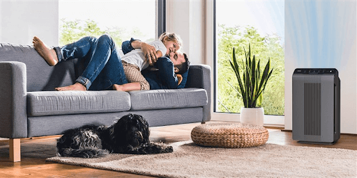 large room with dad and kid on the couch and an air purifier at the side large room with dad and kid on the couch and an air purifier at the side
