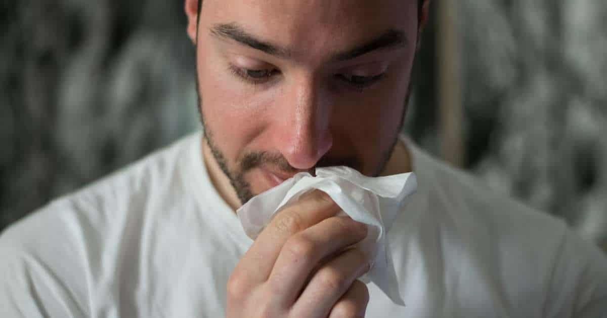 A man having a runny nose due to allergy