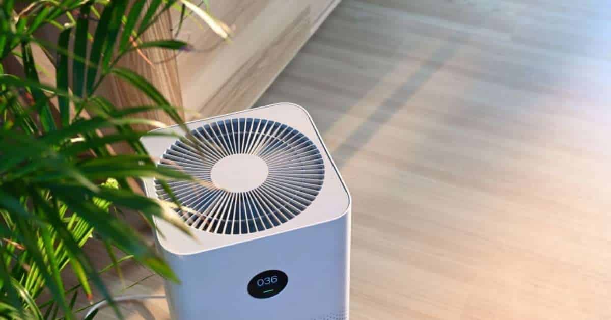 A digital air purifier placed in a room with wooden interior