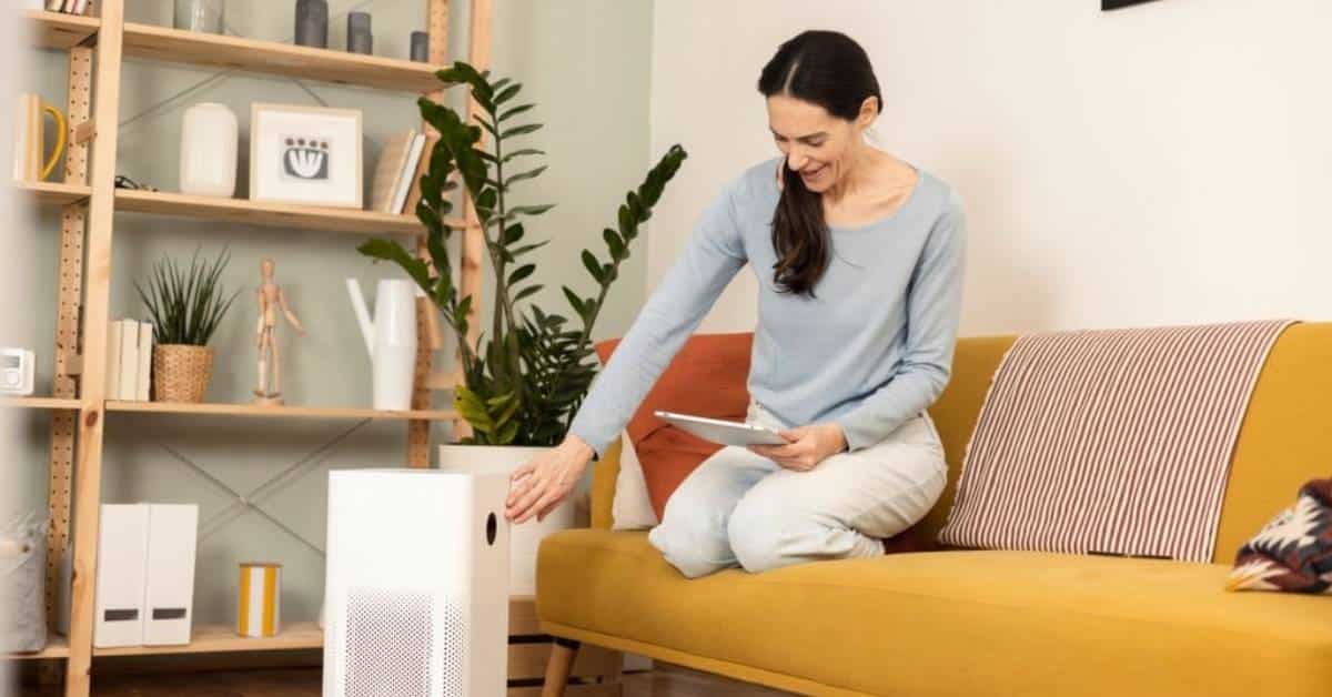 A woman using an air purifier in her living room