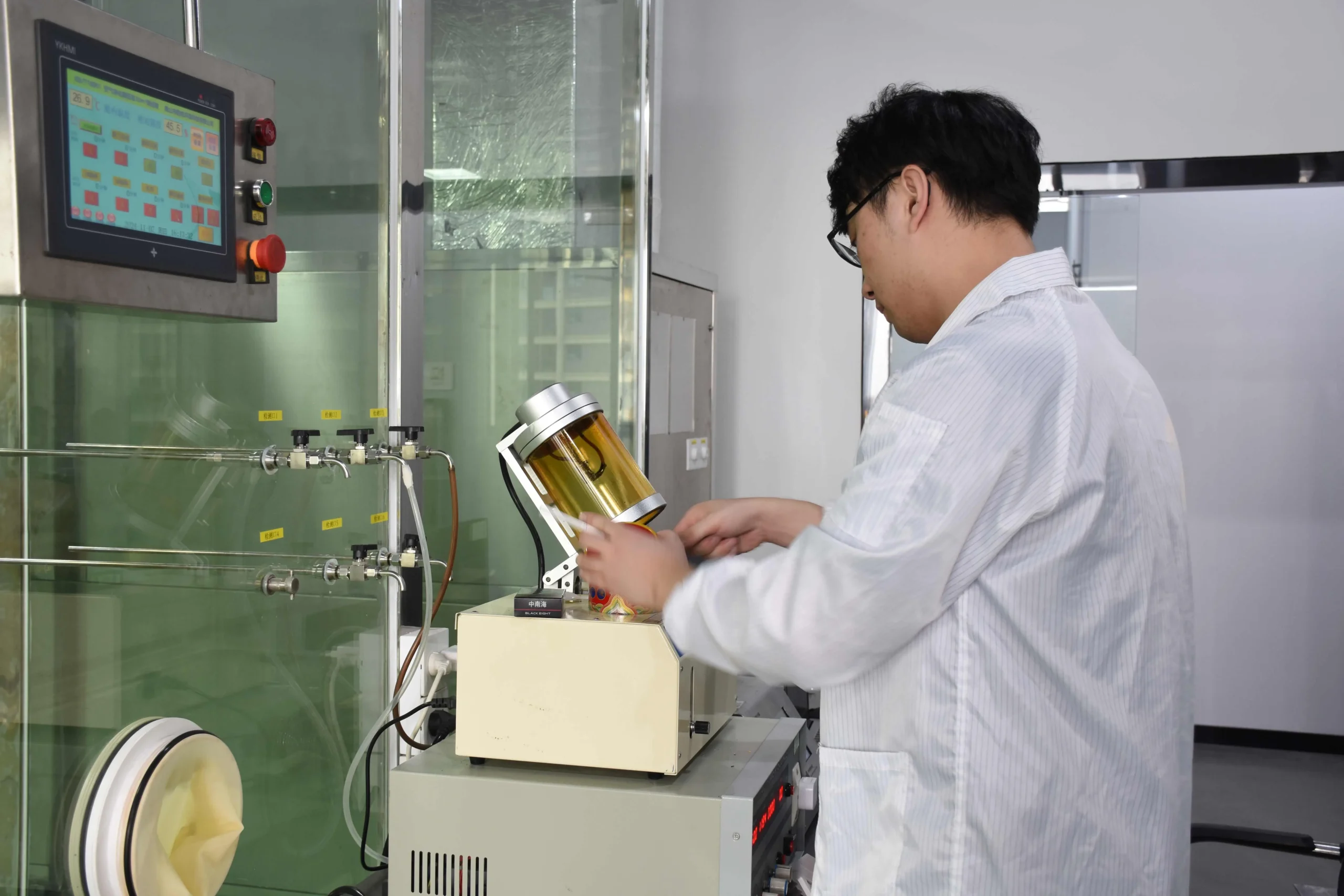 Technician conducting air filter quality testing in a laboratory.