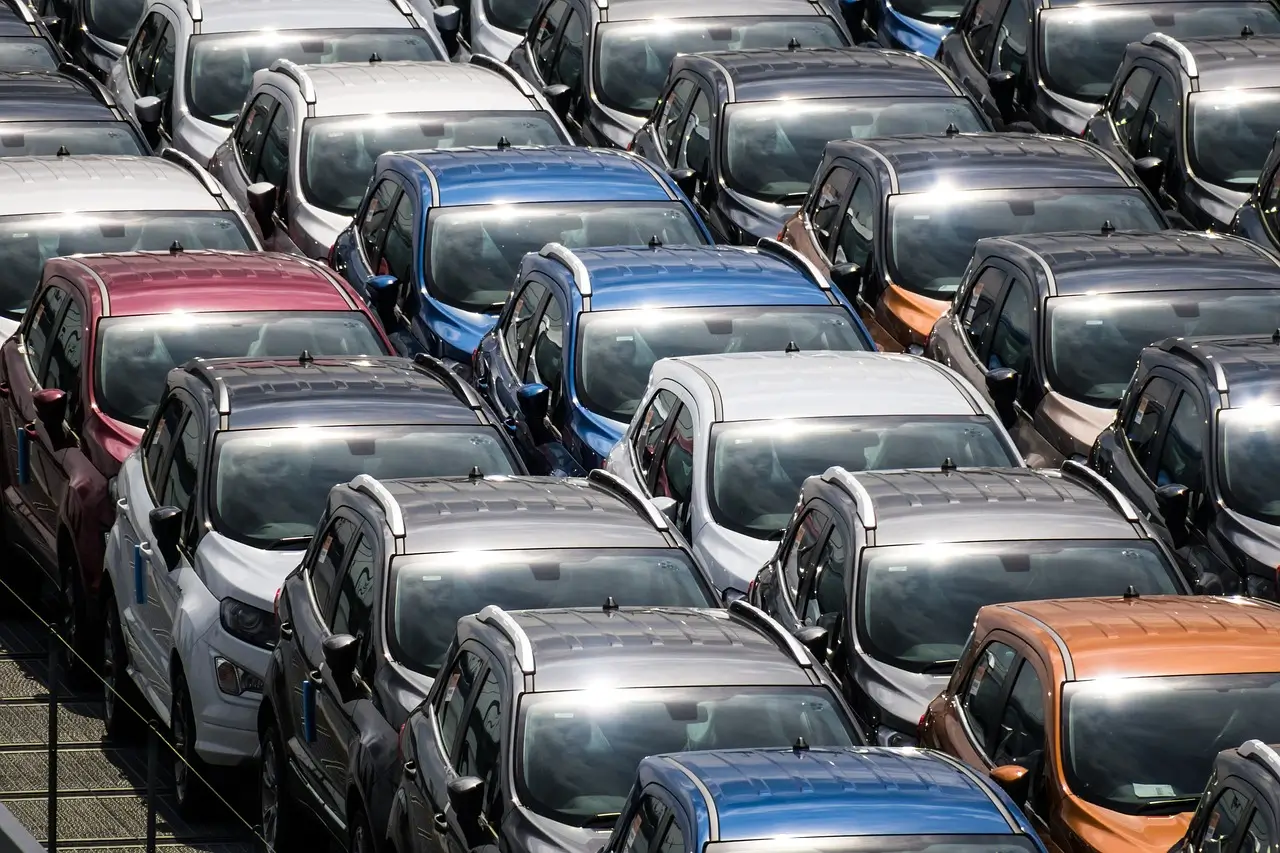 Parking Lot with Multiple Cars of Various Colors Parked in Rows