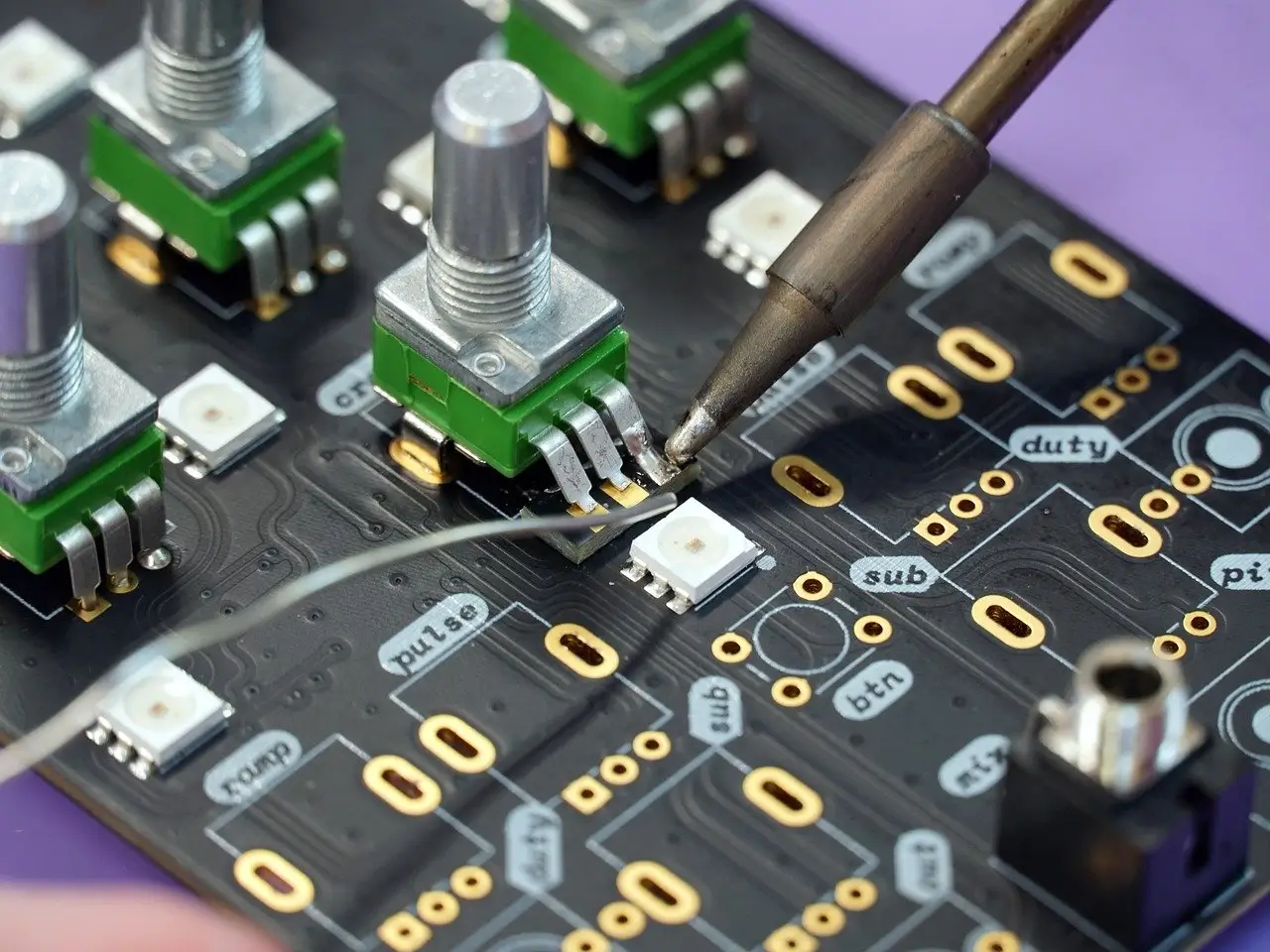 Close-up of Circuit Board in Electronics Manufacturing with Soldering Process Underway