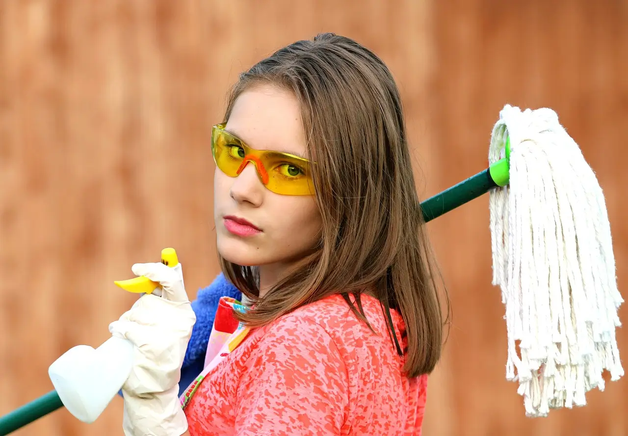 Person cleaning air purifier filter with vacuum cleaner