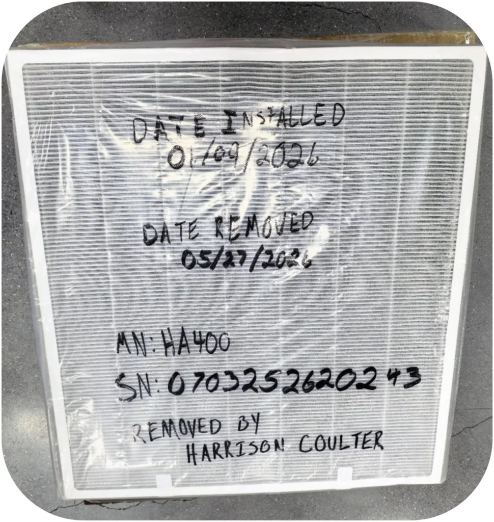 Air filter with handwritten details of installation and removal dates, model number, serial number, and technician name.