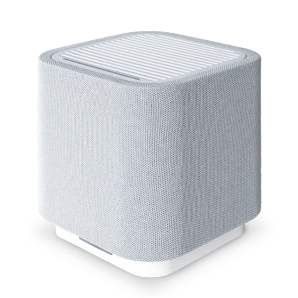 A compact and modern white air purifier with a textured fabric exterior, rounded edges, and a grated vent on the top.